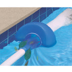Blue pool surface skimmer attached to tiled pool wall edge with white hose, collecting floating leaves from water surface