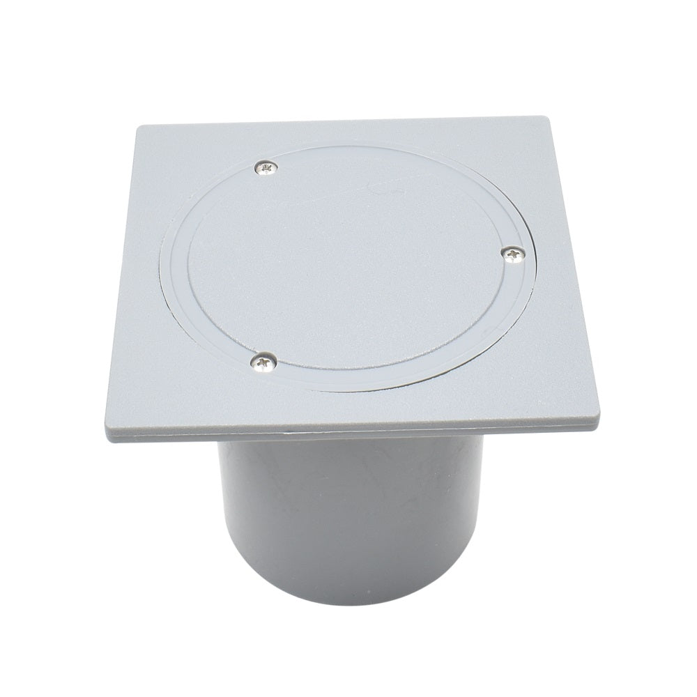 Grey plastic in-ground electrical deck box with square top plate, circular recessed lid, four screws, and cylindrical conduit base