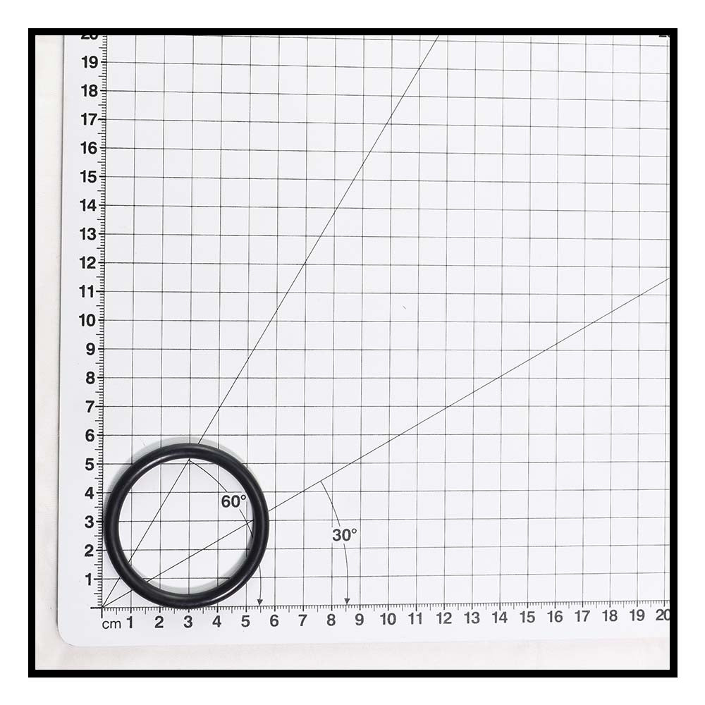 Black rubber O-ring approximately 5cm diameter shown against metric grid mat for scale