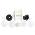 Kreepy Krauly Dominator Lite plastic gear repair kit with white spool, assorted white and black replacement gears on white background