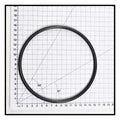 Black rubber O-ring for Speck Pump Lid 90 Series, approximately 14cm diameter, shown on centimetre grid mat