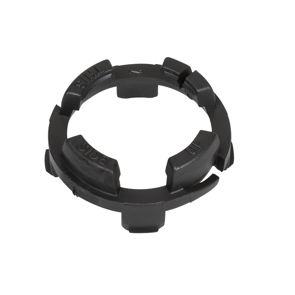 Black plastic compression ring with segmented outer edge, directional "This Side Up" embossed text, and notched locking tabs