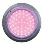 Round LED pool light with silver stainless steel bezel emitting pink-purple colour-changing glow, multi-point screw fixing, retro fit design