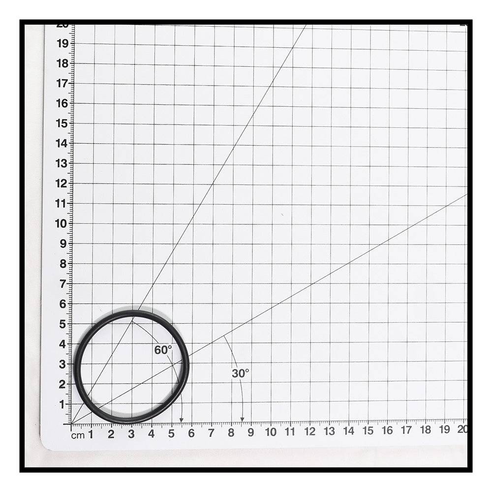 Black rubber O-ring approximately 4cm diameter shown on white metric grid cutting mat with 30° and 60° angle guides for scale reference